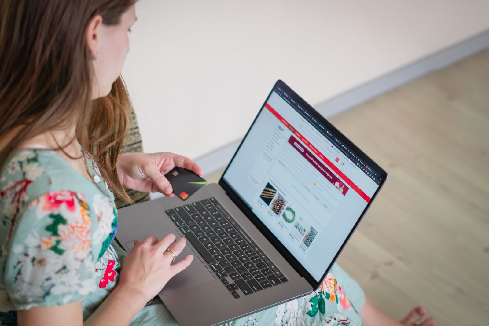 Woman browsing discount cruise sites on a laptop at home